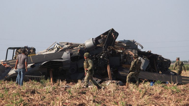 Des soldats se tiennent à côté de l'épave d'un hélicoptère militaire Black Hawk qui s'est écrasé à Los Mochis, dans l'État de Sinaloa, au Mexique