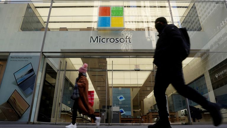 People walk past a Microsoft store in the Manhattan borough of New York City, New York, U.S., January 25, 2021. REUTERS/Carlo Allegri/File Photo