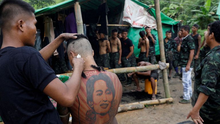 In Myanmar jungle, civilians prepare to battle military rulers. A 34-year-old former fitness trainer and member of the People&#39;s Defence Force (PDF) gets a military-style haircut at a training camp in an area controlled by ethnic Karen rebels, Karen State, Myanmar, September 11, 2021. REUTERS/Independent photographer/File Photo