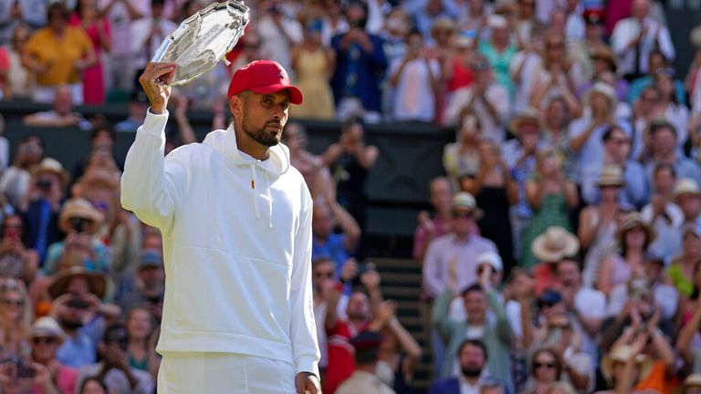 Australia's Nick Kyrgios holds the runners-up trophy after losing to Serbia's Novak Djokovic in the final of the men's singles on day fourteen of the Wimbledon tennis championships in London, Sunday, July 10, 2022. (AP Photo/Alastair Grant)