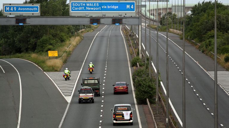 Police escort vehicles along the M4 motorway during the morning rush hour as drivers hold a go-slow protest on the M4. Police have warned of "serious disruption throughout the day" as protesters target motorways in a demonstration over high fuel prices. The protests are understood to be organised via social media under the banner Fuel Price Stand Against Tax. Picture date: Monday July 4, 2022.
