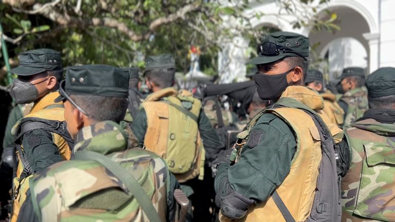 Members of the security force stand guard as people protest at Sri Lanka&#39;s Prime Minister Ranil Wickremesinghe&#39;s office, amid the country&#39;s economic crisis, in Colombo, Sri Lanka July 13, 2022 in this still image obtained from a social media video. Marlon Ariyasinghe/via REUTERS THIS IMAGE HAS BEEN SUPPLIED BY A THIRD PARTY. MANDATORY CREDIT.
