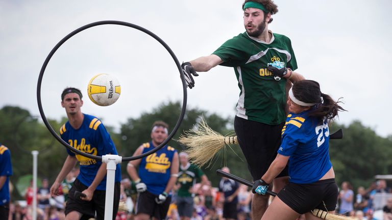 A member of the Loyola University (2nd R in air) quidditch team scores on UCLA&#39;s Tiffany Chow during their match at the Quidditch World Cup VI in Kissimmee, Florida April 14, 2013. REUTERS/Scott Audette (UNITED STATES - Tags: SPORT ENTERTAINMENT SOCIETY)