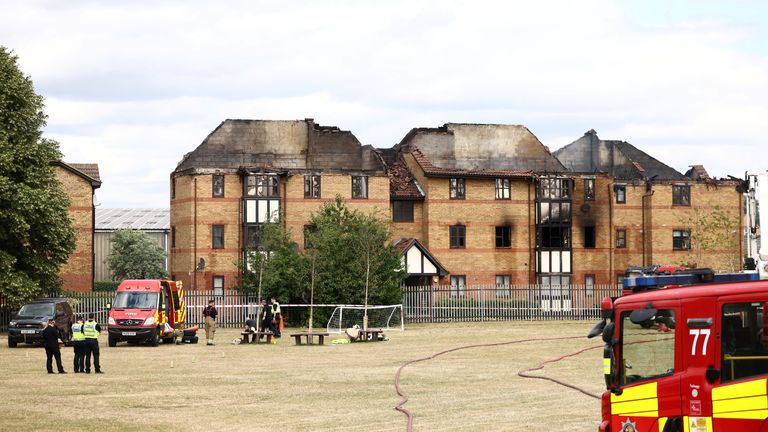 Firefighters and police officers take a break at the scene of a fire at Redwood Grove following a gas explosion, in Bedford, Britain, July 4, 2022. REUTERS/Henry Nicholls
