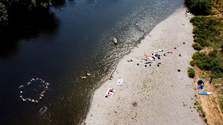 People swim in the River Wye during a heatwave in Britain, July 18, 2022. REUTERS/Carl Recine
