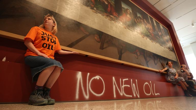 Protesters from Just Stop Oil climate protest group glue their hands to the frame of a copy of Leonardo da Vinci&#39;s, The Last Supper inside the Royal Academy, London. Picture date: Tuesday July 5, 2022.
