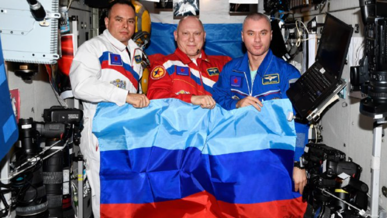 Russian cosmonauts with the flag of the Luhansk People&#39;s Republic aboard the International Space Station. Pic: Roscosmos