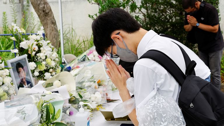People pray for the late Japanese prime minister