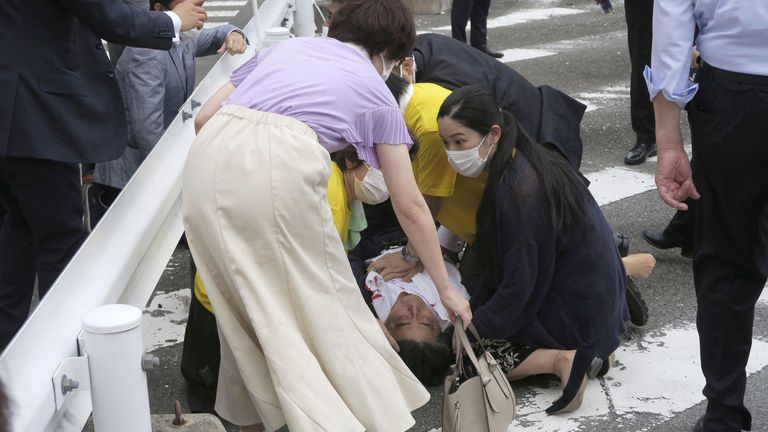 Mr Abe lies on the ground after being shot. Pic: Kyodo Media via Reuters