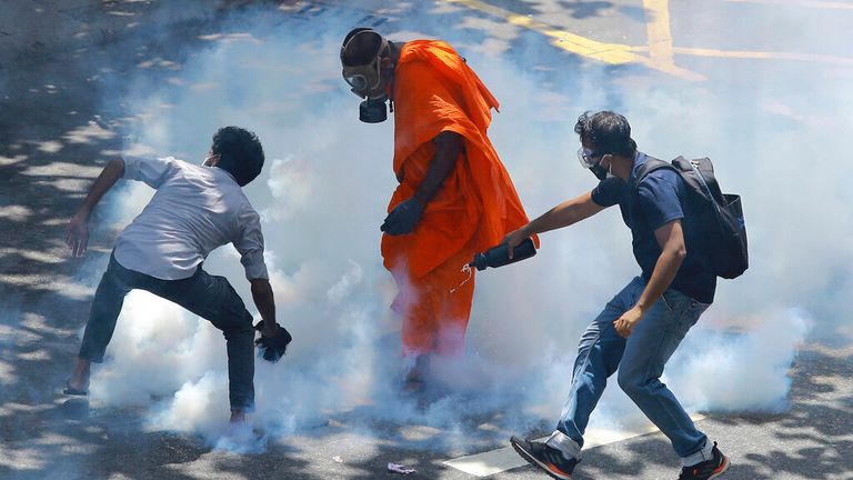 Protesters wear gas masks after tear gas was released Pic: AP 