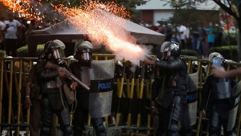 Police use tear gas and water cannon to disperse demonstrators near the president&#39;s residence in Colombo