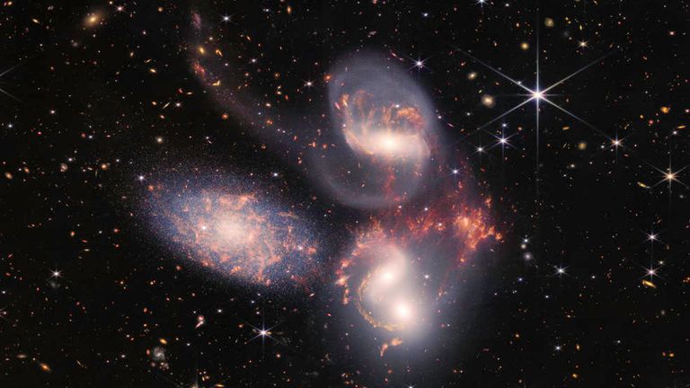 Stephan’s Quintet, a visual grouping of five galaxies, is best known for being prominently featured in the holiday classic film, “It’s a Wonderful Life.” Today, NASA’s James Webb Space Telescope reveals Stephan’s Quintet in a new light.  