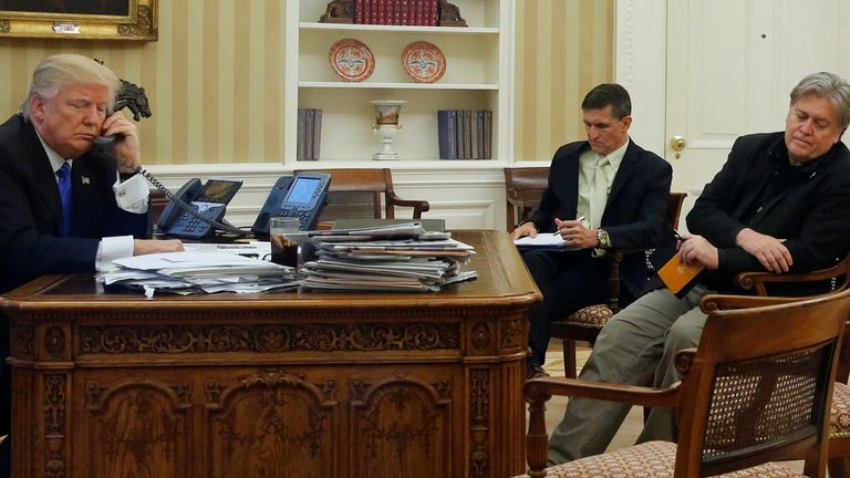 U.S. President Donald Trump (L), seated at his desk with National Security Advisor Michael Flynn (2nd R) and senior advisor Steve Bannon (R), speaks by phone with Australia&#39;s Prime Minister Malcolm Turnbull in the Oval Office at the White House in Washington, U.S. January 28, 2017. REUTERS/Jonathan Ernst