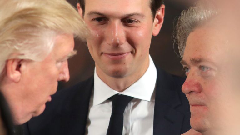 U.S. President Donald Trump talks to senior staffers Steve Bannon and Jared Kushner during the swearing-in ceremony for senior staff at the White House in Washington, D.C.