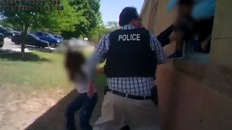 Still from bodycam footage of the police response to the Uvalde shooting in Texas, released alongside a report by the Texas House of Representatives. Image shows children being helped out of a building