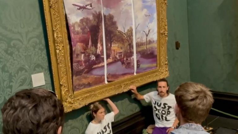 Protesters glue themselves to The Hay Wain's frame after replacing the painting