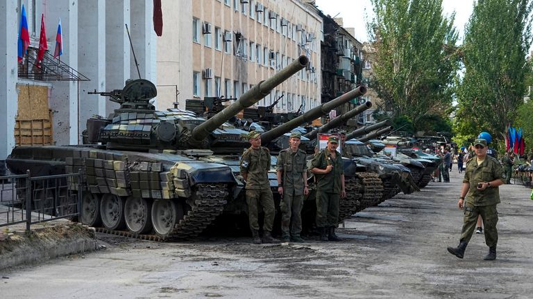 Luhansk People&#39;s Republic people militia servicemen stand at an exhibition of captured Ukrainian tanks and weapons in Lisichansk, on the territory which is under the Government of the control, eastern Ukraine, Tuesday, July 12, 2022. This photo was taken during a trip organized by the Russian Ministry of Defense. (AP Photo)
