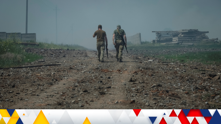 Ukrainian service members walk on the road near the town of Soledar, amid Russia&#39;s invasion of Ukraine, Donetsk region, Ukraine June 8, 2022. REUTERS/Gleb Garanich