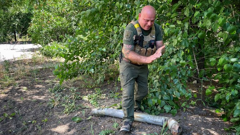 A Ukrainian policeman shows unexploded ordnance