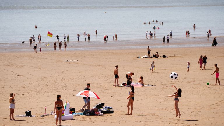 People on the beach at Barry Island, Wales enjoying the hot weather,as Britons are set to sizzle on what could be the hottest day of the year so far, with temperatures predicted to possibly hit 33C. Picture date: Monday July 11, 2022.
