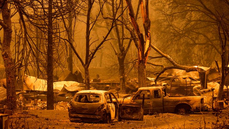 Scorched vehicles and residences line the Oaks Mobile Home Park in the Klamath River community as the McKinney Fire burns in Klamath National Forest, Calif., Saturday, July 30, 2022. (AP Photo/Noah Berger)
