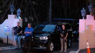 Armed Secret Service agents stand outside an entrance to former President Donald Trump's Mar-a-Lago estate, late Monday, Aug. 8, 2022, in Palm Beach, Fla. Trump said in a lengthy statement that the FBI was conducting a search of his Mar-a-Lago estate and asserted that agents had broken open a safe. (AP Photo/Terry Renna)
