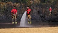 Firefighters battle a grass fire in the Leyton Flats, London, Friday, Aug. 12, 2022. A drought has been officially declared in some parts of southern and central England, following the driest summer of the past fifty years.(AP Photo/Alberto Pezzali)