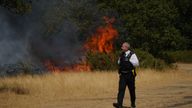 Police officers near the scene of a grass fire on Leyton flats in east London as a drought has been declared for parts of England.
