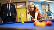 Embargoed to 2230 Monday August 8 Conservative Party leadership candidate Liz Truss plays pool as former Conservative Party leader Ian Duncan Smith looks on, during a visit to the Onside Future Youth Zone in London. Picture date: Monday August 8, 2022.
