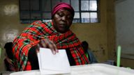 A voter casts her ballot during the general election by the Independent Electoral and Boundaries Commission (IEBC) at the Kibera primary school in Nairobi, Kenya August 9, 2022. REUTERS/Thomas Mukoya
