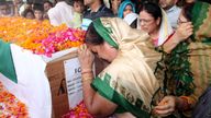 A woman cries by the coffin containing the remains of Chandra Shekhar