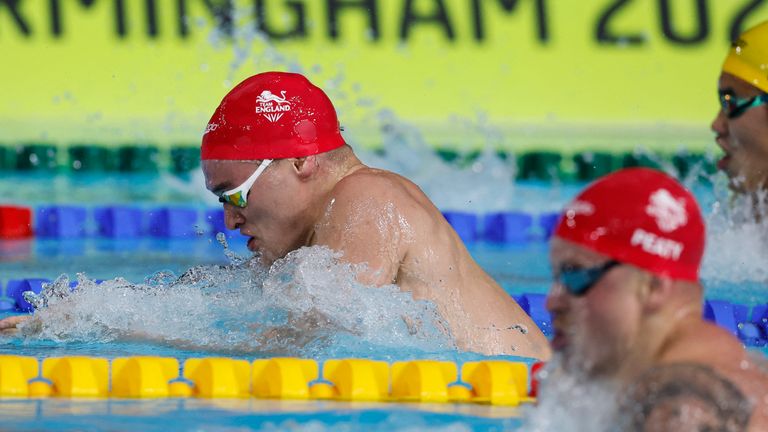 Commonwealth Games - Men&#39;s 100m Breaststroke - Final - Sandwell Aquatics Centre, Birmingham, Britain - July 31, 2022 England&#39;s James Wilby and Adam Peaty and Australia&#39;s Joshua Yong in action REUTERS/Stefan Wermuth