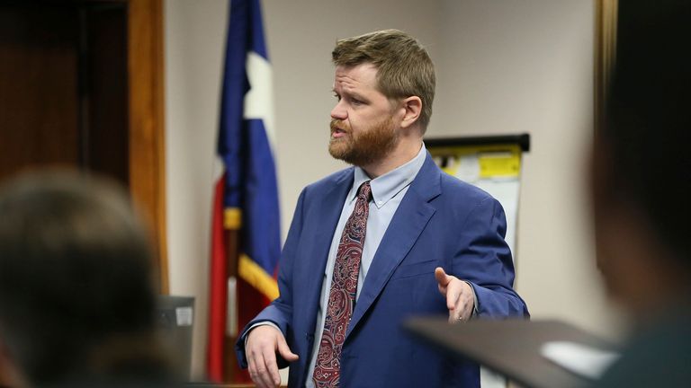 Mark Bankston, lawyer for Neil Heslin and Scarlett Lewis, asks Alex Jones about the profits he makes a day during a trial at the Travis County Courthouse, Wednesday Aug. 3, 2022, in Austin, Texas. Jones has been found to have defamed the parents of a Sandy Hook student for calling the attack a hoax. (Briana Sanchez/Austin American-Statesman via AP)