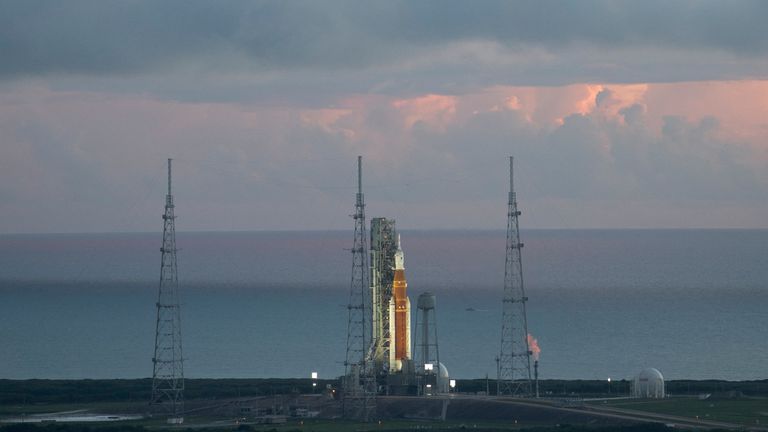 NASA's Space Launch System (SLS) rocket with the Orion spacecraft on board is seen at sunrise atop the mobile launch pad at Launch Pad 39B, as Artemis I launch teams load more than 700,000 gallons of cryogenic propellant cold consisting of liquid hydrogen and liquid oxygen as the launch countdown progresses at NASA's Kennedy Space Center at Cape Canaveral,  