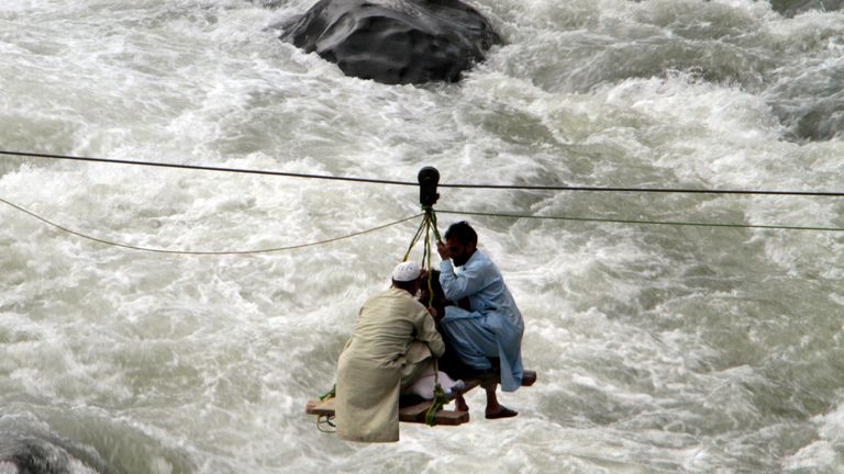 People cross a river on a suspended cradle, in the town of Bahrain, Pakistan, Tuesday, Aug. 30, 2022. The United Nations and Pakistan issued an appeal Tuesday for $160 million in emergency funding to help millions affected by record-breaking floods that have killed more than 1,150 people since mid-June. (AP Photo/Naveed Ali)
PIC:AP