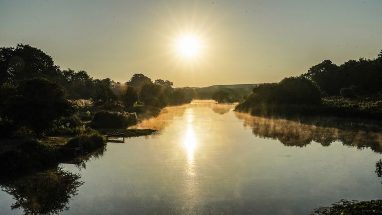 The sun rises over Berwick Pond in Rainham, Essex. Picture date: Thursday August 11, 2022.
