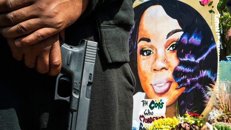 A protestor shows his weapon at the memorial of Breonna Taylor before a march, after a grand jury decided not to bring homicide charges against police officers involved in the fatal shooting of Taylor in her apartment, in Louisville, Kentucky, U.S. September 25, 2020. REUTERS/Eduardo Munoz
