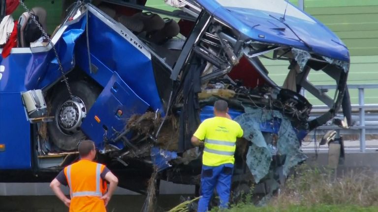 
Workers clear the wreckage of a Polish bus which skidded off a highway in Croatia, killing at least 12 people. 
