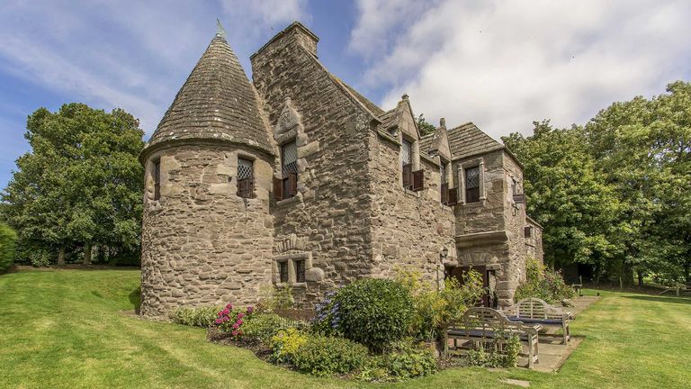 Powrie Castle features turrets and leaded glass windows