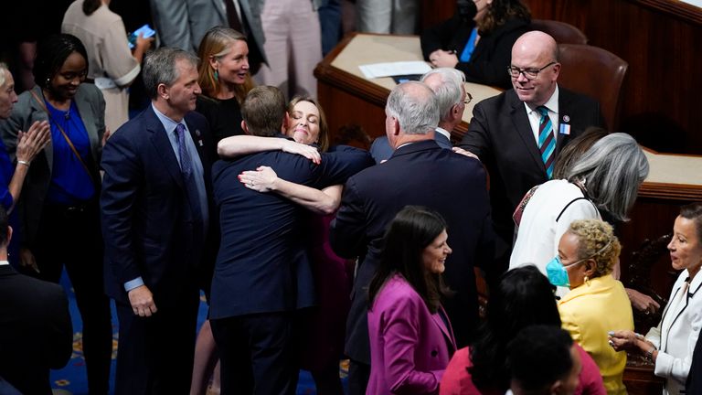 Members of the House of Representatives celebrate after the vote to approve the Inflation Reduction Act. Pic: AP
