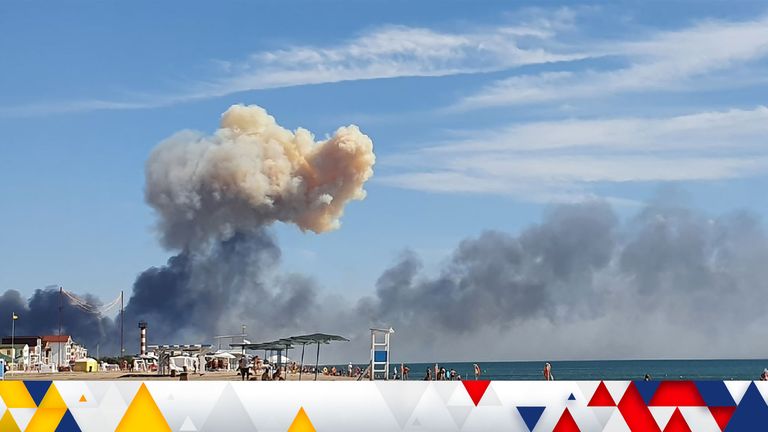 Rising smoke can be seen from a beach near the air base