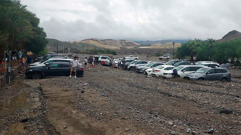 In this photo provided by the National Park Service, cars are stuck in mud and debris due to flash flooding at the Inn at Death Valley in Death Valley National Park, California on Friday, August 5, 2022. Heavy rain triggered flooding sudden events that closed several roads in Death Valley National Park on Friday near the California-Nevada line.  The National Weather Service reported that all roads in the park were closed after 1-2 inches of rain fell in a short amount of time.  (National Park Service via AP)