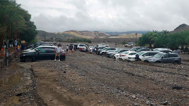 In this photo provided by the National Park Service, cars are stuck in mud and debris from flash flooding at The Inn at Death Valley in Death Valley National Park, Calif., Friday, Aug. 5, 2022. Heavy rainfall triggered flash flooding that closed several roads in Death Valley National Park on Friday near the California-Nevada line. The National Weather Service reported that all park roads had been closed after 1 to 2 inches of rain fell in a short amount of time. (National Park Service via AP)