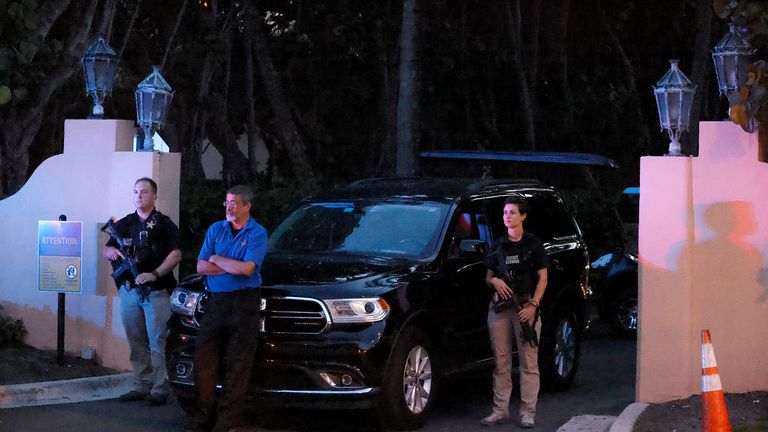 Armed Secret Service agents stand outside an entrance to former President Donald Trump&#39;s Mar-a-Lago estate, late Monday, Aug. 8, 2022, in Palm Beach, Fla. Trump said in a lengthy statement that the FBI was conducting a search of his Mar-a-Lago estate and asserted that agents had broken open a safe. (AP Photo/Terry Renna)