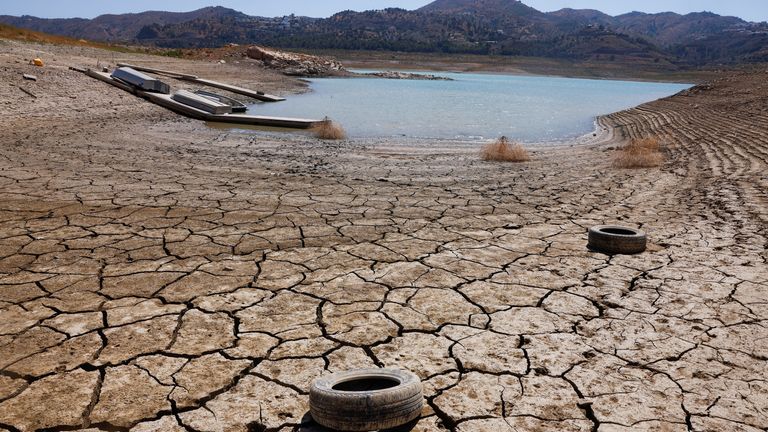 Tires lie on the cracked ground of La Vinuela reservoir during a severe drought in La Vinuela, near Malaga, southern Spain August 8, 2022. A prolonged dry spell and extreme heat that made last July the hottest month in Spain since at least 1961, have left Spanish reservoirs at just 40% of capacity on average in early August, well below the ten-year average of around 60%, official data shows.REUTERS/Jon Nazca
