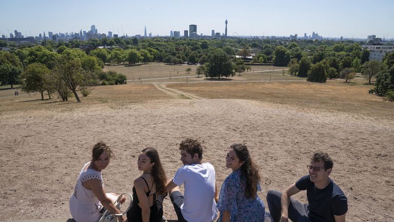 People enjoy the hot weather on Primrose Hill in London where the grass is dry due to lack of water. The Met Office has issued an amber warning for extreme heat covering four days from Thursday to Sunday for parts of England and Wales as a new heatwave looms. Picture date: Tuesday August 9, 2022.