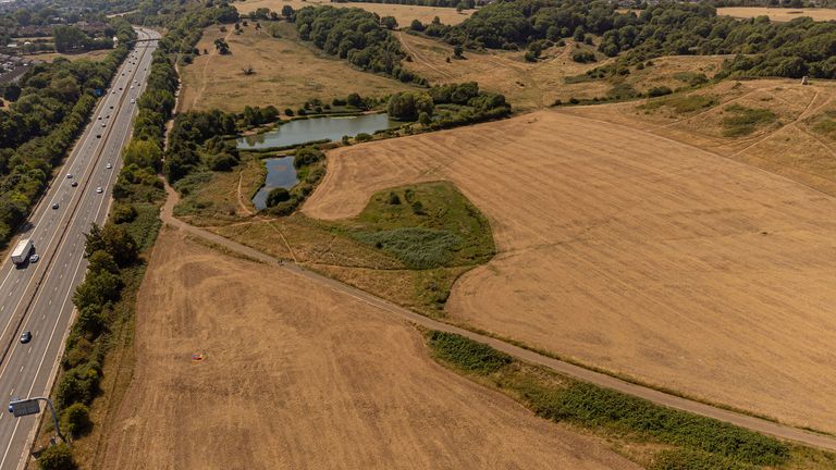 Dry grass fields next to the M32 motorway at Stoke Park, Bristol. The Met Office has issued an amber warning for extreme heat covering four days from Thursday to Sunday for parts of England and Wales. Picture date: Saturday August 13, 2022.