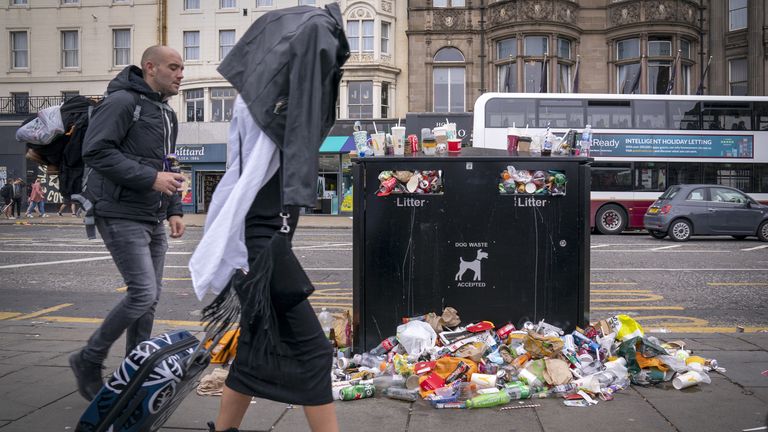 Bins and litter along Princes Street in Edinburgh city centre as cleansing workers from the City of Edinburgh Council are on the fourth day of eleven days of strike action. Workers at waste and recycling depots across the city have rejected a formal pay offer of 3.5 percent from councils body Cosla. Picture date: Monday August 22, 2022.

