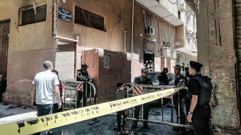 14 August 2022, Egypt, Gize: Security personnel stand at the cordoned scene where a massive fire broke out during a Sunday service at the Abu Sefein Coptic church in Giza. At least 41 people have died and dozens were severely injured after a mass fire broke out at the Coptic church. Photo by: Mahmoud El-Khawas/picture-alliance/dpa/AP Images

