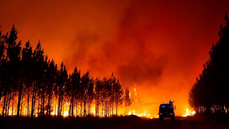This photo provided by the SDIS 33 fire service of the Gironde region (SDIS 33 departmental fire service) shows firefighters fighting a fire near Saint-Magne, south of Bordeaux, southwestern France, Wednesday, Aug. 10, 2022. (SDIS 33 ) via AP)